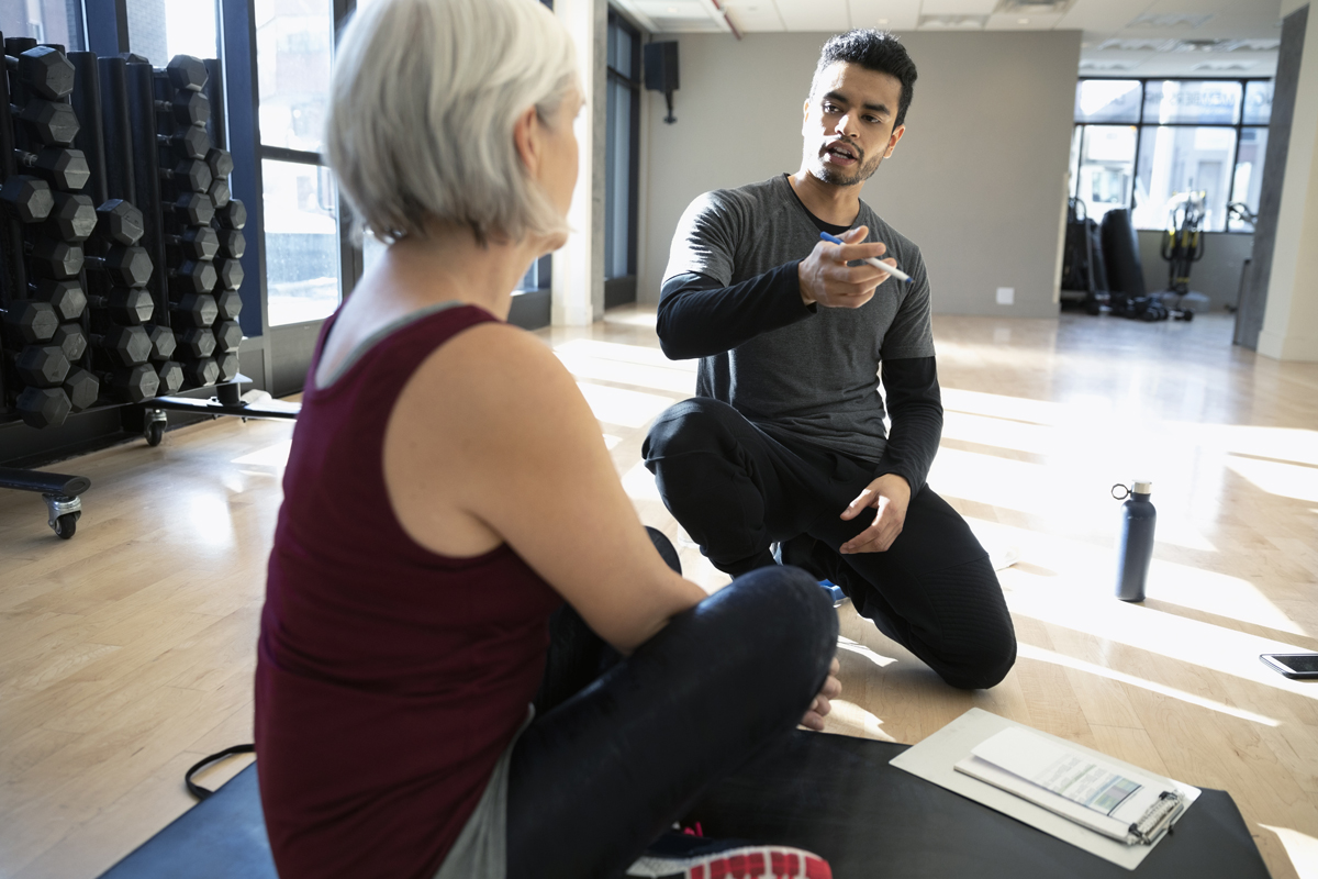 Personal trainer and client discussing bone health